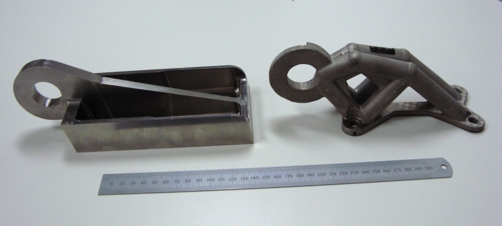 Figure 2.  An aero type component shown on the left as machined from a Ti64 billet and on the right after topology optimisation and SLM manufacture.   The part on the right is about 50 percent lighter compared to the part on the left with similar design load carrying capability.   