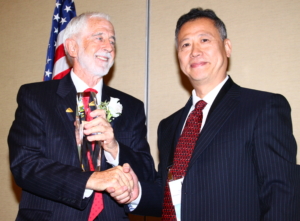 LIA's 2016 President Lin Li (right) presents Executive Director Peter Baker with the first LIA Leadership Award
